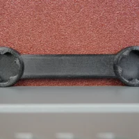 Black 3D-printed wrench with four-pointed sockets on each end, designed to fit Ridgid sander adjustment knobs