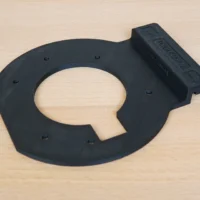 Black 3D-printed guide rail adapter for Festool OF 1010 router with central oval opening and mounting holes
