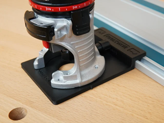 Rail adapter for Porter Cable trim router mounted on black base, silver and black metal housing with red depth scale ring visible above