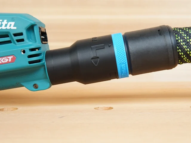 Black hose adapter with blue band attached to Makita 40v XGT sander dust port, shown from the side