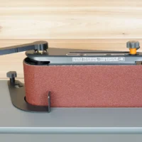 Ridgid oscillating sander wrench with black metal handle and orange knob, mounted on a gray track showing the wrench gripping the adjustment knob