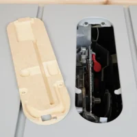 Beige MDF zero clearance insert shown from above alongside the metal SawStop Jobsite PRO table saw insert it replaces, revealing internal mechanism and red trigger component