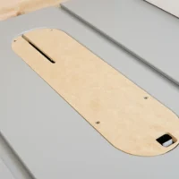Natural wood zero clearance insert for SawStop Jobsite PRO table saw, showing slot for blade, mounting holes, and adjustment port at bottom