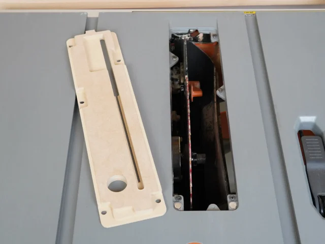 Cream-colored MDF zero clearance insert for Ridgid R4513 table saw, shown next to the original metal insert for comparison
