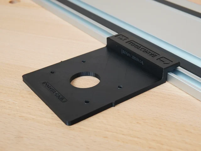 Black Rail Adapter for Porter Cable Trim Router mounted on an aluminum guide rail, shown from above on a wooden workbench