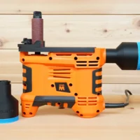 Black 2-1/2 inch hose adapter with blue band shown beside and installed on an orange WEN handheld spindle sander