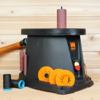 Black 1-1/4 inch hose adapter with blue ring beside a WEN oscillating spindle sander, orange hose attached