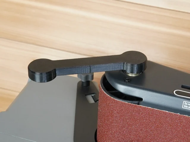 Black PETG wrench with curved ends mounted over adjustment knob on Ridgid oscillating sander