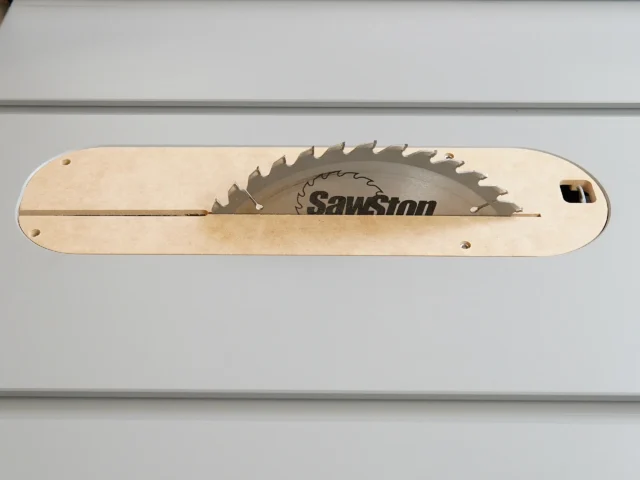 Light wood zero clearance insert for SawStop table saw with sawblade cutout and mounting holes