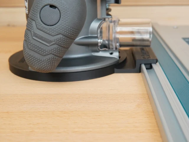 Ridgid 2 HP router attached to a Festool guide rail via black adapter base, mounted on wooden workbench
