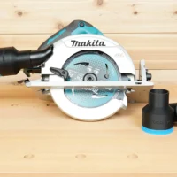 Black ToolCurve 2-1/2 inch hose adapter with blue trim beside a Makita cordless circular saw with hose attached