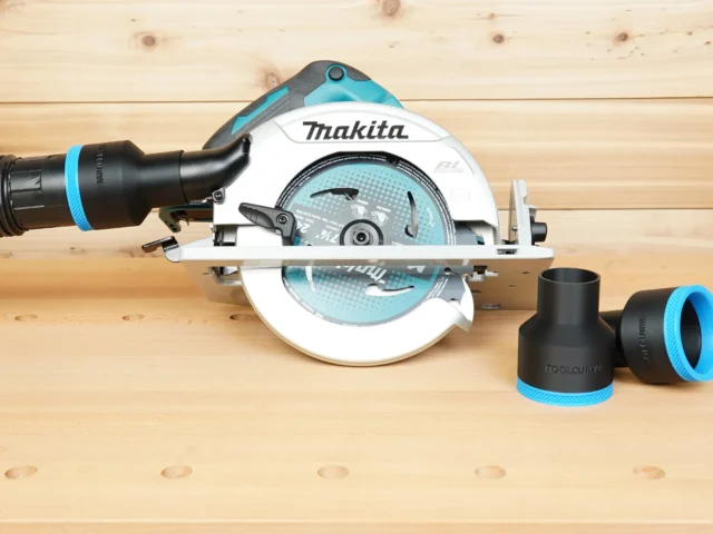 Black ToolCurve 2-1/2 inch hose adapter with blue trim beside a Makita cordless circular saw with hose attached