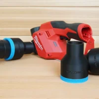 Black ToolCurve 2-1/2 in hose adapters with blue rings beside a red Milwaukee M12 planer and vacuum hose