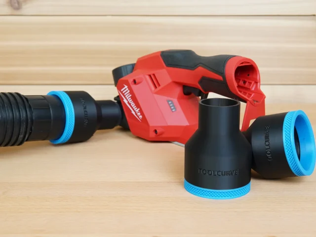 Black ToolCurve 2-1/2 in hose adapters with blue rings beside a red Milwaukee M12 planer and vacuum hose