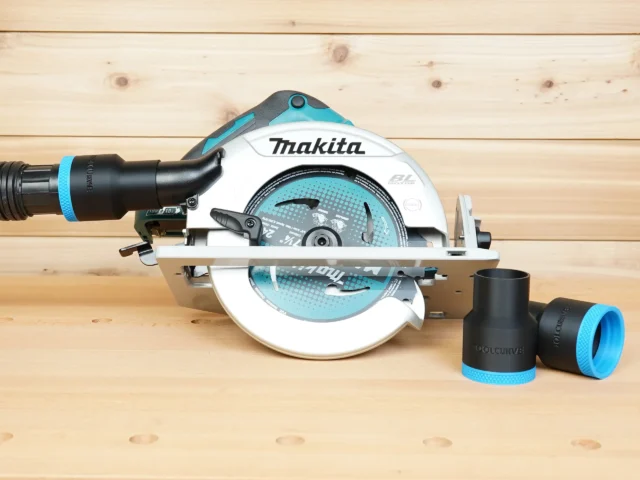 Black ToolCurve 1-7/8 inch hose adapter with blue trim installed on a Makita cordless circular saw, plus two loose adapters