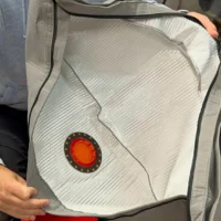 Macam reusable dust bag with red and orange circular inlet seal, held open to show white polyester interior lining