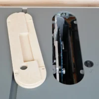 Zero clearance insert for Hercules 10" table saw shown from above, natural MDF finish on left, black insert mounted in saw on right