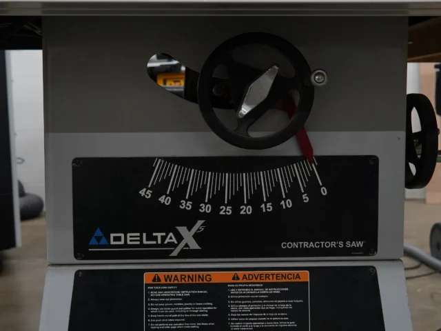 Zero clearance insert installed in Delta Unisaw X5 table saw, viewed from above showing blade opening and angle gauge