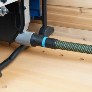 Black ToolCurve hose adapter with blue ring joining a braided vacuum hose to a Hercules table saw dust port