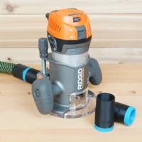 Black ToolCurve hose adapter with blue cuff connecting a vacuum hose to a Ridgid 2 HP fixed base router, second adapter beside it