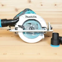Black 36mm hose adapter with blue trim installed on a Makita 7-1/4 in circular saw, with a second adapter beside it