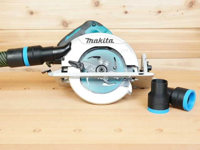 Black 36mm hose adapter with blue trim installed on a Makita 7-1/4 in circular saw, with a second adapter beside it
