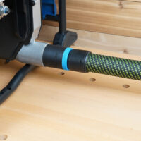Black 36mm hose adapter with blue ring joining a green braided hose to a Hercules table saw dust port