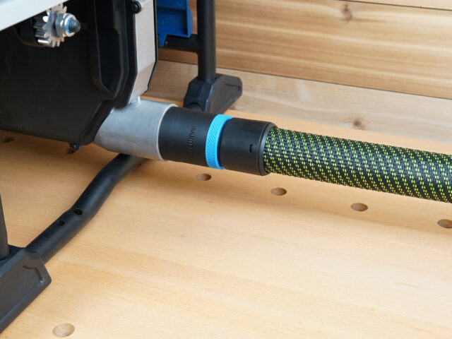 Black 36mm hose adapter with blue ring joining a green braided hose to a Hercules table saw dust port