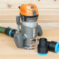 Black 36mm ToolCurve hose adapter shown beside a Ridgid 2 HP fixed base router, second adapter joined to a green hose