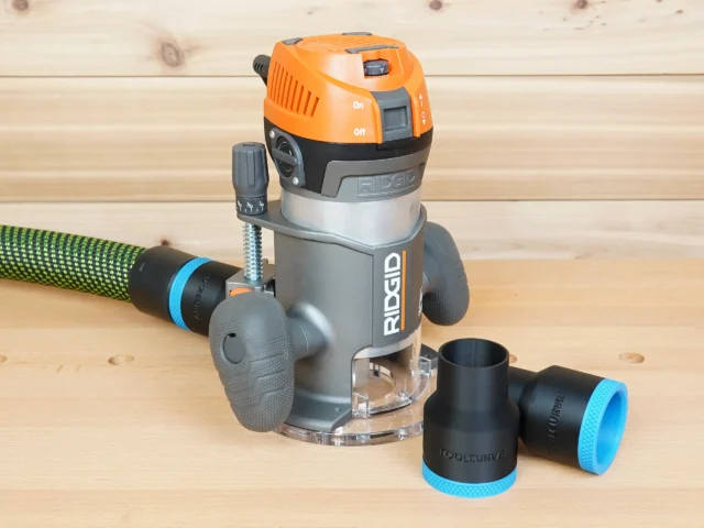 Black 36mm ToolCurve hose adapter shown beside a Ridgid 2 HP fixed base router, second adapter joined to a green hose