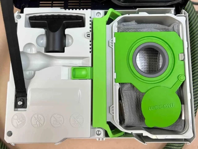 Macam reusable filter bag in bright green, shown inside its white storage case alongside instruction manual and gray fabric pouch