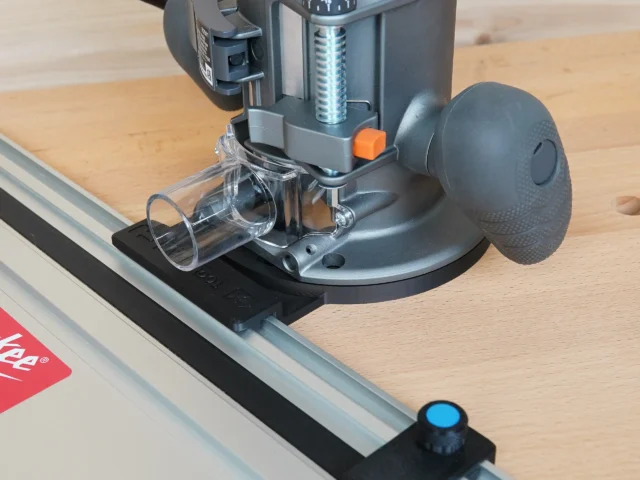 Guide rail adapter mounted on Ridgid 2 HP router base, attached to aluminum track saw rail on wooden workbench