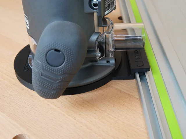 Guide rail adapter mounted on Ridgid 2 HP router, attached to aluminum track with green edge guard