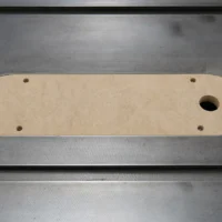 MDF zero clearance insert for Delta Unisaw X5 with four mounting holes and central blade slot, top view