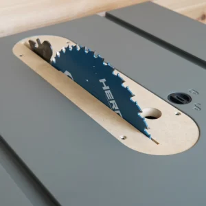 MDF zero clearance insert seated in a gray Hercules 10-inch table saw with blue blade and riving knife raised through the slot
