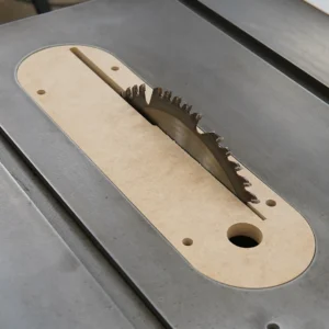 MDF zero clearance insert seated in a Delta Unisaw X5 table saw with the blade raised through the slot