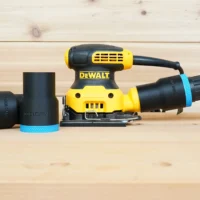 Black 1-7/8 inch ToolCurve hose adapter with blue rings, one installed on a DeWalt palm sander dust port
