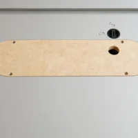 Beige MDF zero clearance insert for Kobalt 10-inch table saw, viewed from above, with four mounting holes and one centered blade opening