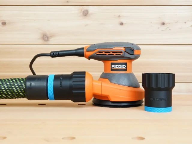 Black 36mm ToolCurve hose adapter with blue ring shown beside a Ridgid 5 in. sander and attached to a hose