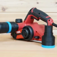 Black 36mm hose adapter with blue ring joining a dust hose to a red SKIL planer, second adapter alongside