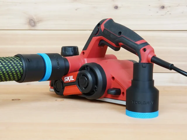 Black 36mm hose adapter with blue ring joining a dust hose to a red SKIL planer, second adapter alongside