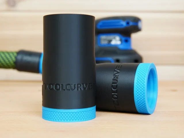 Black ToolCurve hose adapter with blue textured grip band, shown with matching adapters and Kreg sander in background