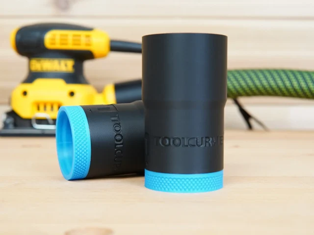 Black ToolCurve hose adapter with bright blue grip ring, shown alone and installed on a Dewalt palm sander in background