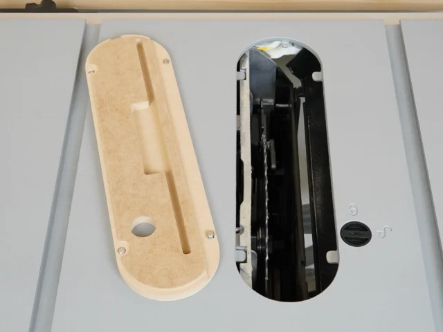 Tan MDF insert and black factory insert side by side, both showing top view with mounting holes and center slots for Kobalt 10" table saw