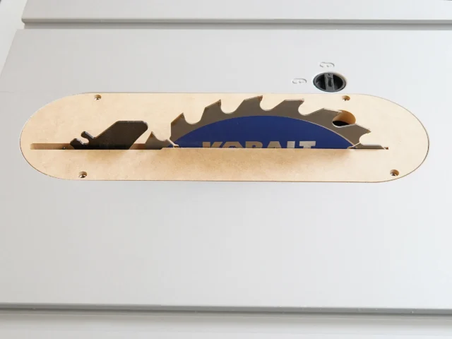 Zero clearance insert for Kobalt 10" table saw, light wood MDF with cutout for saw blade, mounted in saw table