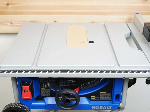 Zero clearance insert installed on Kobalt 10-inch table saw, showing beige MDF top surface with center opening and offset adjustment screw