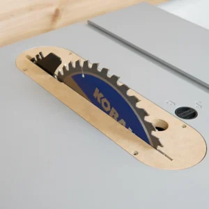 MDF zero clearance insert seated in a Kobalt 10-inch table saw with blade raised through the slot