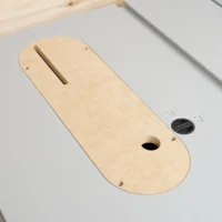 Zero clearance insert for Kobalt 10″ table saw, wood-colored MDF with slot for blade and mounting holes, shown installed in saw table