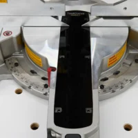 Black zero clearance insert installed on Dewalt 12-inch miter saw between the aluminum fences, viewed from above