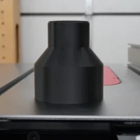 Black hose adapter for SawStop 4" rear dust port, shown standalone with conical shape and top opening